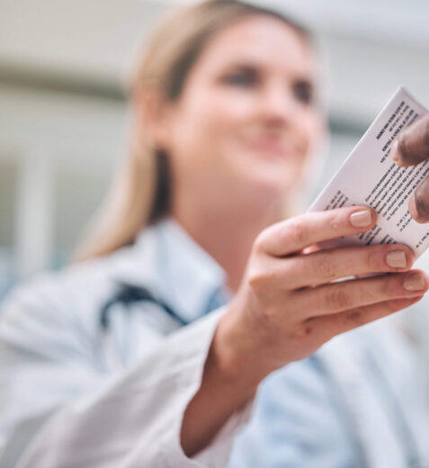 Patient Handing Medicare Card To Doctor