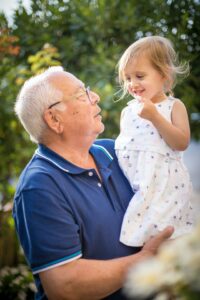 grandfather holding granddaughter