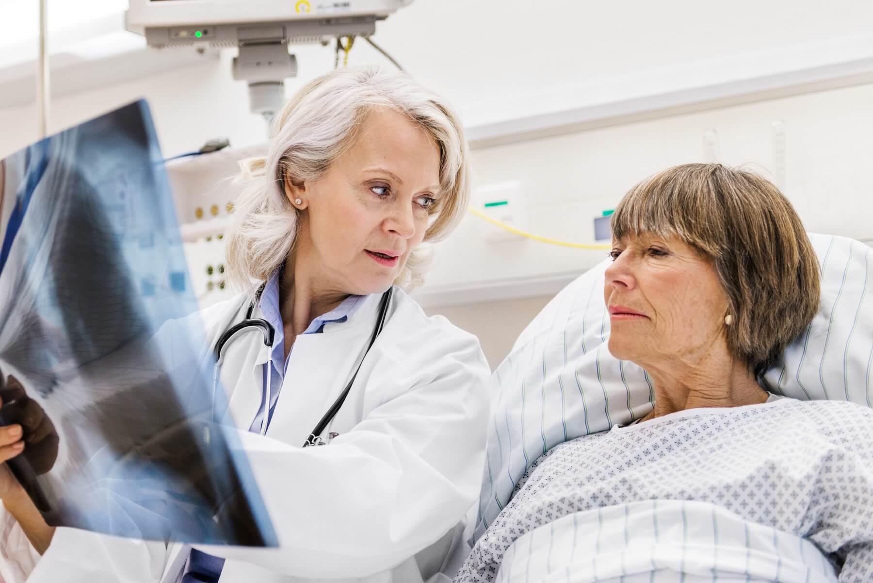 Doctor Showing Elderly Patient An Xray