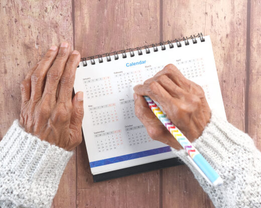 person marking calendar date