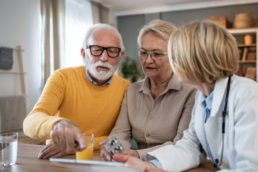 Older couple meeting with a doctor to review Medicare Supplement Plan G coverage and medication costs.